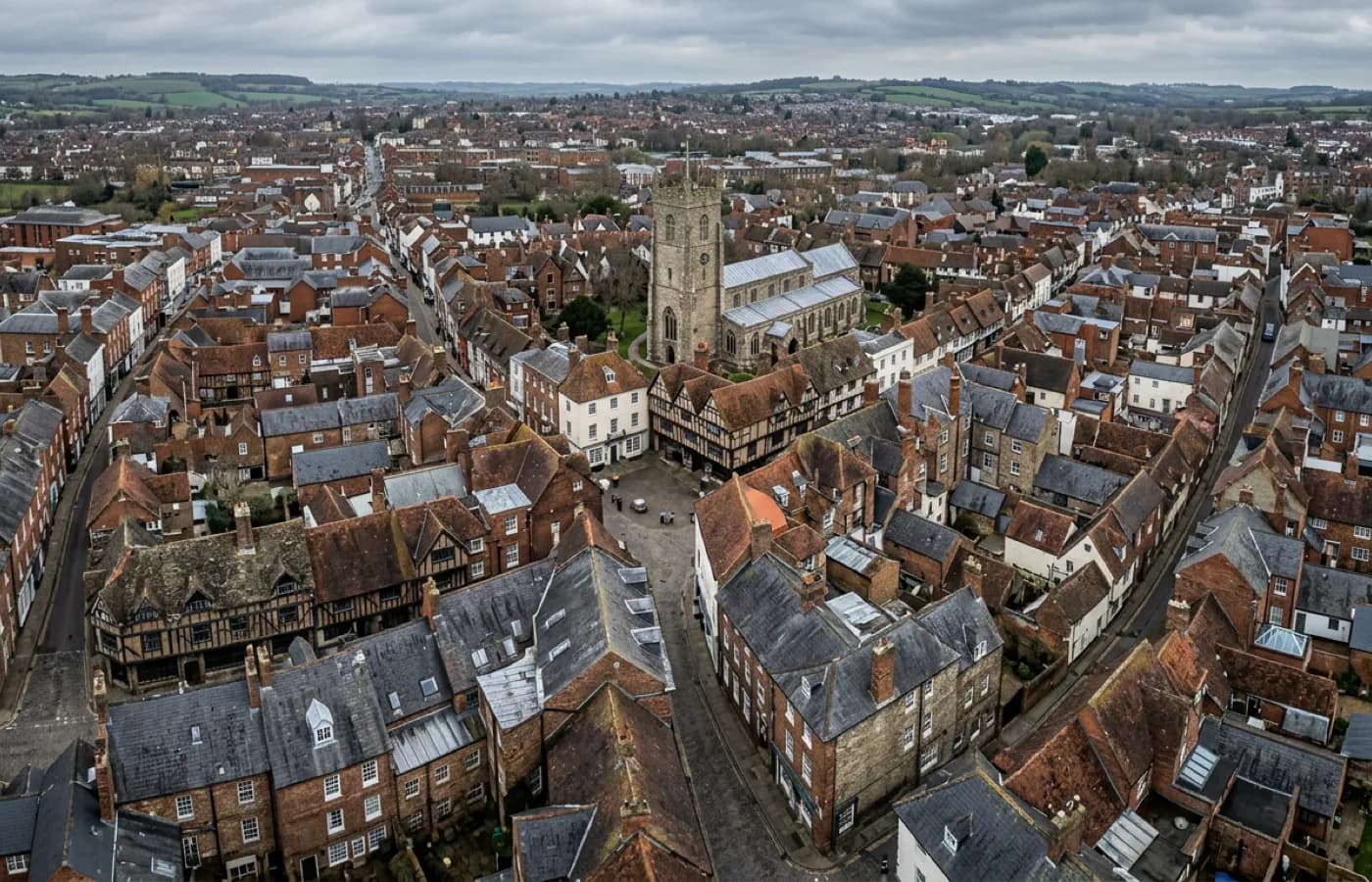 Aerial view over a historic town centre with a tight medieval and Georgian street grid