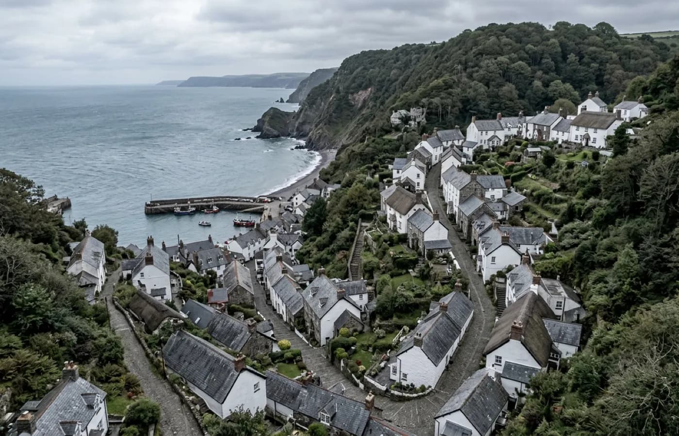 Aerial view over a steep hillside town with houses stacked on an incline down to the water